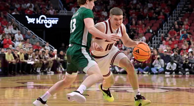 Nov 15, 2025; Louisville, Kentucky, USA; Louisville Cardinals guard Isaac McKneely (10) dribbles against Ohio Bobcats guard Jackson Paveletzke (13) during the first half at KFC Yum! Center. Mandatory Credit: Jamie Rhodes-Imagn Images