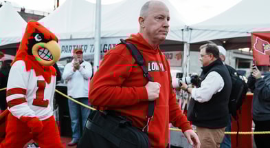 Louisville football coach Jeff Brohm leads the team as the Cards head to the locker room at the Cards March before the Louisville football game against Clemson at L&N Stadium Friday. Nov. 14, 2025