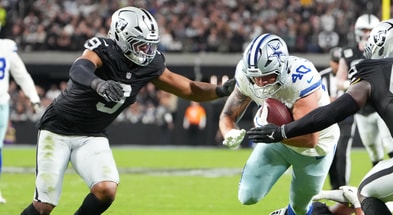 Nov 17, 2025; Paradise, Nevada, USA; Dallas Cowboys running back Hunter Luepke (40) is tackled by Las Vegas Raiders defensive end Tyree Wilson (9) and linebacker Devin White (45) at Allegiant Stadium