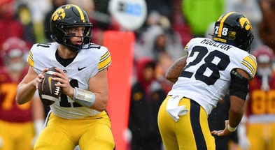 Iowa Hawkeyes quarterback Mark Gronowski (11) drops back to pass against the Southern California Trojans during the first half at the Los Angeles Memorial Coliseum. - Gary A. Vasquez, USA TODAY Sports