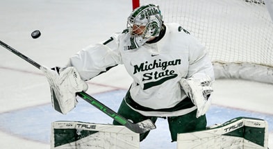 Michigan State's Trey Augustine deflects a Minnesota shot during overtime on Saturday, Jan. 25, 2025, at Munn Arena in East Lansing. - Nick King, USA TODAY Sports