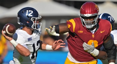 Georgia Southern Eagles quarterback JC French IV (12) is pressured by USC Trojans defensive tackle Keeshawn Silver (9) during the first half at United Airlines Field at the Los Angeles Memorial Coliseum