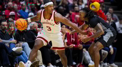 Nov 21, 2025; Cincinnati, Ohio, USA; Louisville Cardinals guard Ryan Conwell (3) dribbles the ball against Cincinnati Bearcats guard Day Day Thomas (1) in the second half at Heritage Bank Center. Mandatory Credit: Aaron Doster-Imagn Images