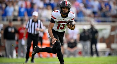 Nov 22, 2025; Dallas, Texas, USA; Louisville Cardinals quarterback Deuce Adams (13) runs with the ball against the SMU Mustangs during the first half at Gerald J. Ford Stadium. Mandatory Credit: Jerome Miron-Imagn Images