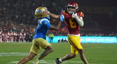 USC Trojans wide receiver Makai Lemon (6) carries the ball against UCLA Bruins defensive back Andre Jordan Jr. (2) in the second half at United Airlines Field at Los Angeles Memorial Coliseum