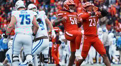 Wesley Bailey, Clev Lubin and Louisville celebrate sack in 41-0 win over Kentucky.