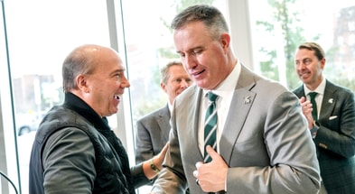 Greg Williams, left, shakes hands with Michigan State's new football coach Pat Fitzgerald during the coach's introductory press conference on Tuesday, Dec. 2, 2025, at the Tom Izzo Football Building. - Nick King, USA TODAY Sports