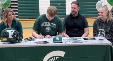 Michigan State offensive tackle signee Tristan Comer with his family on signing day (photo by Kenny Jordan for SpartanMag.com).