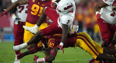 Fresno State Bulldogs running back Jordan Mims (7) is tackled by USC Trojans defensive back Anthony Beavers Jr. (15) in the first half at United Airlines Field at Los Angeles Memorial Coliseum
