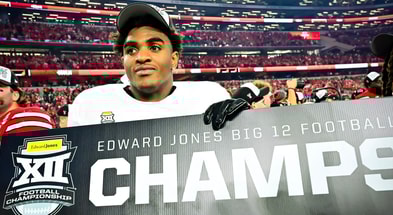 Texas Tech EDGE Romello Height holding a "Big 12 Champs" sign