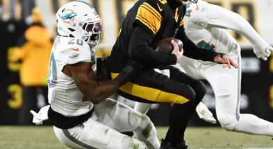 Dec 15, 2025; Pittsburgh, Pennsylvania, USA; Pittsburgh Steelers quarterback Aaron Rodgers (8) is sacked by Miami Dolphins linebacker Jordyn Brooks (20) in the first quarter at Acrisure Stadium.