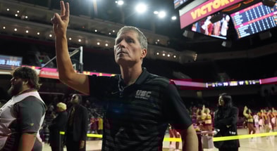 USC Trojans head coach Eric Musselman holds up Fight On sign after victory against the UTSA Roadrunners at the Galen Center