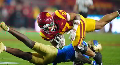 USC Trojans running back Riley Wormley (27) is tackled by UCLA Bruins defensive back Aaron Williams (7) in the first half at United Airlines Field at Los Angeles Memorial Coliseum