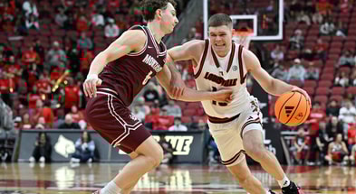 Dec 20, 2025; Louisville, Kentucky, USA; Louisville Cardinals guard Isaac McKneely (10) dribbles against Montana Grizzlies guard Tyler Isaak (8) during the second half at KFC Yum! Center. Louisville defeated Montana 94-54. Mandatory Credit: Jamie Rhodes-Imagn Images