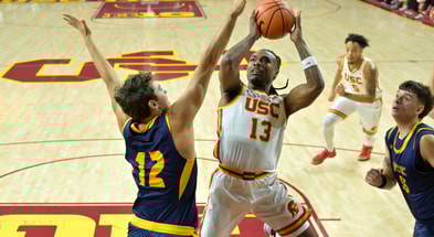 UC Santa Cruz Banana Slugs guard Thomas Conley (12) defends a shot by USC Trojans guard Kam Woods (13) in the first half at Galen Center