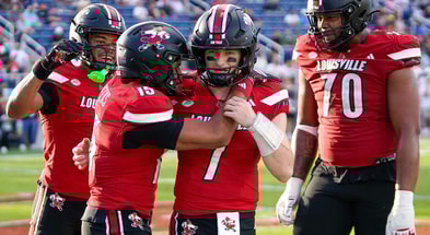 Dec 23, 2025; Boca Raton, FL, USA; Louisville Cardinals quarterback Miller Moss (7) and wide receiver Antonio Meeks (15) celebrate a touchdown pass against the Toledo Rockets during the third quarter of the Boca Raton Bowl at Flagler CU Stadium. Mandatory Credit: Jeff Romance-Imagn Images