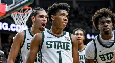 Michigan State's Jeremy Fears Jr., center, leaves the court with Jesse McCulloch, left, and Coen Carr, right, after Fears' shot to end the first half against Cornell on Monday, Dec. 29, 2025. - Nick King, USA TODAY Sports