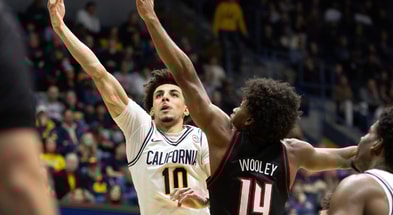 Dec 30, 2025; Berkeley, California, USA; California Golden Bears guard Justin Pippen (10) lays the ball up ahead of Louisville Cardinals guard Adrian Wooley (14) during the second half at Haas Pavilion. Mandatory Credit: D. Ross Cameron-Imagn Images
