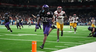 TCU Horned Frogs running back Jeremy Payne (26) scores on a 35-yard touchdown reception in overtime for the winning score against the USC Trojans during the Alamo Bowl at Alamodome