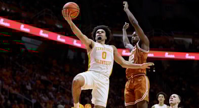 Jan 6, 2026; Knoxville, Tennessee, USA; Tennessee Volunteers guard Ja'kobi Gillespie (0) goes to the basket against Texas Longhorns guard Tramon Mark (12) during the first half at Thompson-Boling Arena at Food City Center. Mandatory Credit: Randy Sartin-Imagn Images