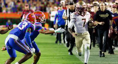 Nov 29, 2025; Gainesville, Florida, USA; Florida State Seminoles wide receiver Lawayne McCoy (7) runs against Florida Gators defensive back Alfonzo Allen Jr. (43) during the second half at Ben Hill Griffin Stadium. Mandatory Credit: Matt Pendleton-Imagn Images