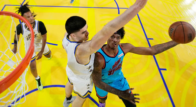 February 14, 2025; San Francisco, California, USA; Team G-League guard Dink Pate (1) of the Mexico City Capitanes drives to the basket against Team C forward Zach Edey (14) of the Memphis Grizzlies during the 2025 NBA Rising Stars Game at Chase Center. Mandatory Credit: Kyle Terada-Imagn Images