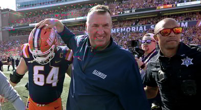 Sep 27, 2025; Champaign, Illinois, USA; Illinois Fighting Illini head coach Bret Bielema gives players a hand after a 34-32 win against the Southern California Trojans at Memorial Stadium. Mandatory Credit: Ron Johnson-Imagn Images