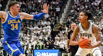 Michigan State's Jordan Scott, right, looks to pass as UCLA's Tyler Bilodeau closes in during the first half on Tuesday, Feb. 17, 2026, at the Breslin Center in East Lansing. - Nick King, USA TODAY Sports