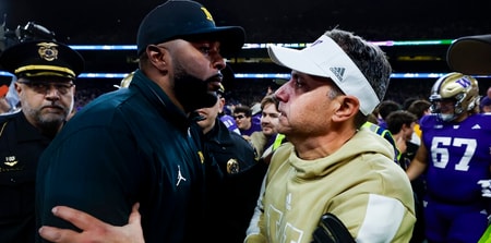 Oct 5, 2024; Seattle, Washington, USA; Michigan Wolverines head coach Sherrone Moore, left, shakes hands with Washington Huskies head coach Jedd Fisch, right, following a Washington victory at Alaska Airlines Field at Husky Stadium. Mandatory Credit: Joe Nicholson-Imagn Images