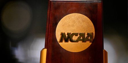 Apr 19, 2025; Fort Worth, TX, USA; A view of the NCAA logo and trophy before the 2025 Women's National Gymnastics Championship at Dickies Arena. Mandatory Credit: Jerome Miron-Imagn Images