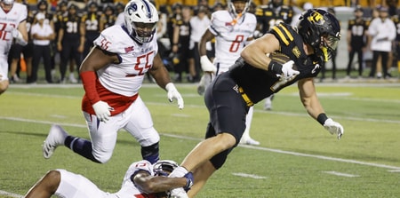 Running back Anderson Castle tries to break free of a tackle attempt.