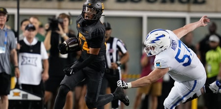 Sep 14, 2024; Waco, Texas, USA; Baylor Bears safety Corey Gordon Jr. (24) evades Air Force Falcons offensive lineman Gabriel Averitt (57) after making an interception against Air Force Falcons quarterback Josh Johnson (11) during the second half at McLane Stadium. Mandatory Credit: Chris Jones-Imagn Images