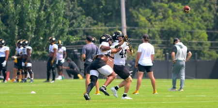 Josiah Trotter (left) and Jackson Daily (right) fight for a ball during a drill