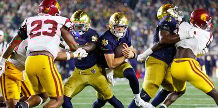 Notre Dame quarterback CJ Carr, center, runs with the ball in the second half of a NCAA football game against USC at Notre Dame Stadium on Saturday, Oct. 18, 2025, in South Bend
