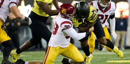 USC Trojans defensive lineman Jack Sullivan (99) tackles Oregon Ducks running back Jordan James (20) during the second half at Autzen Stadium