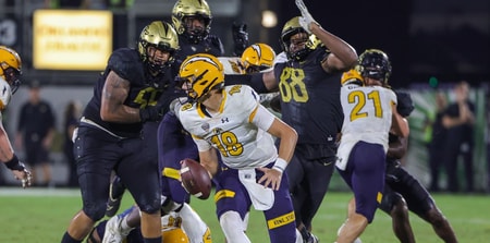 Aug 31, 2023; Orlando, Florida, USA; Kent State Golden Flashes quarterback Michael Alaimo (18) moves out to pass as UCF Knights defensive end Josh Celiscar (88) and defensive tackle John Walker (55) move in during the second half at FBC Mortgage Stadium. Mandatory Credit: Mike Watters-Imagn Images battle for the ball