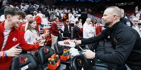 Louisville Cardinals head coach Pat Kelsey signed a fan's Adidas shoe after the Cards beat NC State in ACC basketball February 9, 2026 in Louisville, Kentucky.© Matt Stone/Courier Journal / USA TODAY NETWORK via Imagn Images