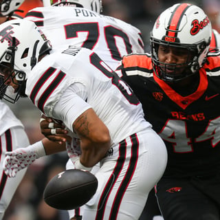 Oregon State's Takari Hickle, right, knocks the ball away from Texas Tech's Cameron Dickey during an NCAA football game at Reser