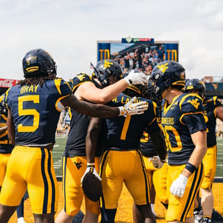 West Virginia celebrates Kedrick Triplett's first touchdown