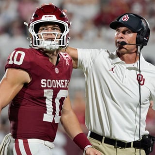 Oklahoma Sooners quarterback John Mateer (10) and coach Brent Venables talk after a play during a college football game between the University of Oklahoma Sooners (OU) and the New Mexico Lobos at Gaylord Family-Oklahoma Memorial Stadium in Norman, Okla., Saturday, Sept. 19, 2026. Oklahoma won 14-6.