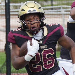 Iona Preps Chase Reeves (26) looks for some running room in the Paramus Catholic defense on a first half run during football