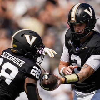 Vanderbilt quarterback Jared Curtis (2) hands off to running back Sedrick Alexander (28) during the first quarter against NC