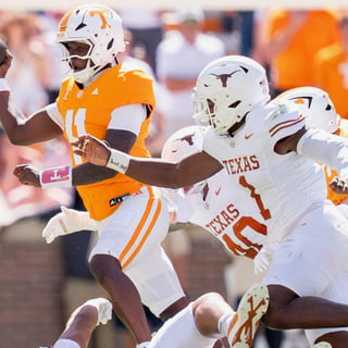 Sep 26, 2026; Knoxville, Tennessee, USA; Tennessee quarterback Faizon Brandon (11) is swarmed by Texas defenders during a college football game between Tennessee and Texas at Neyland Stadium in Knoxville, Tenn. on Sept. 26, 2026. Mandatory Credit: Brianna Paciorka-USA TODAY Network via Imagn Images