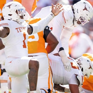 Texas edge Colin Simmons (1) celebrates after Tennessee quarterback Faizon Brandon (11) is sacked again during a college