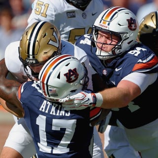 Xavier Atkins and Cody Sigler combine for a tackle against Vanderbilt. (Photo by USA Today Network)