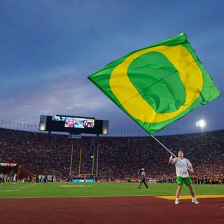 An Oregon cheerleader celebrates a touchdown as the Oregon Ducks face the USC Trojans on Sept. 26, 2026, at Los Angeles Memorial
