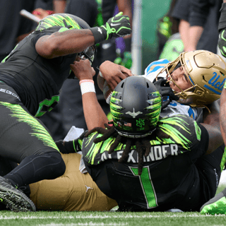 UCLA QB Nico Iamaleava tackled by Oregon DL Bear Alexander