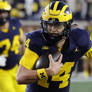 Oct 17, 2026; Ann Arbor, Michigan, USA; Michigan Wolverines quarterback Tommy Carr (14) runs the ball in the second half against the Penn State Nittany Lions at Michigan Stadium. Mandatory Credit: Rick Osentoski-Imagn Images