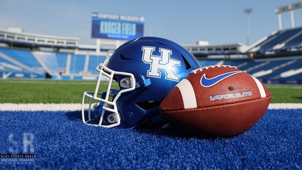 Football in front of a Kentucky helmer at Kroger Field