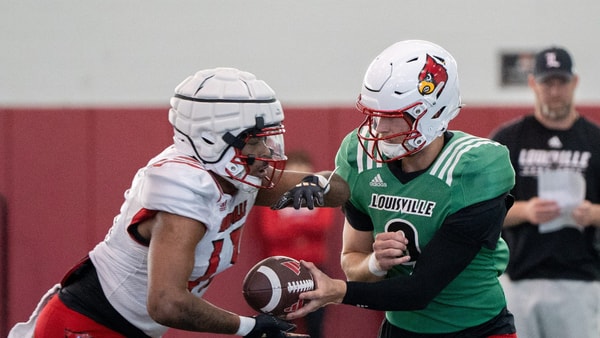 Louisville football quarterback Tyler Shough (9) and running back Peny Boone (13) run drills during spring practice on Saturday, March 23, 2024 at the Trager practice facility in Louisville, Ky.